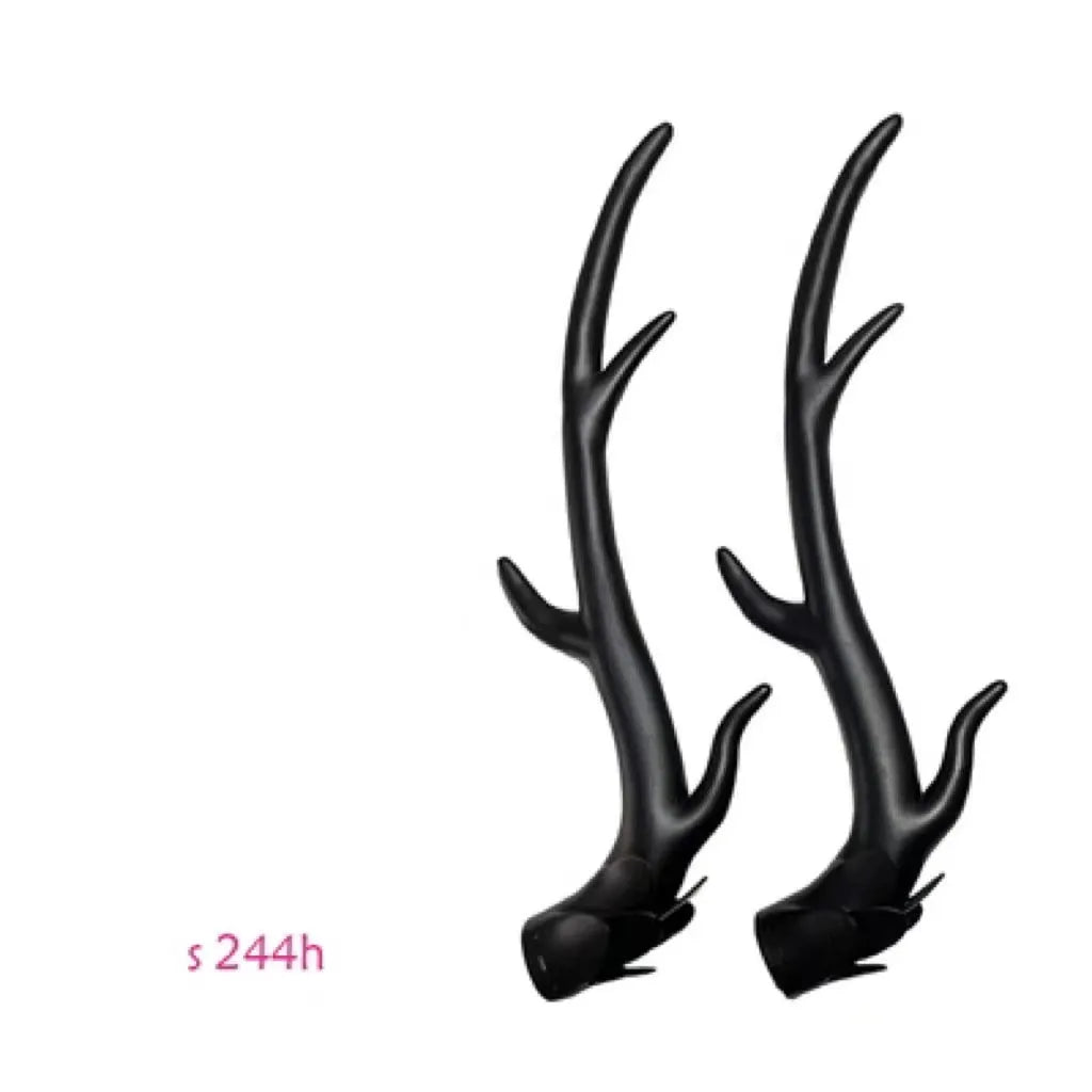 A pair of resin dragon horn decorations for motorcycle helmets in black, shown next to a ruler for scale.