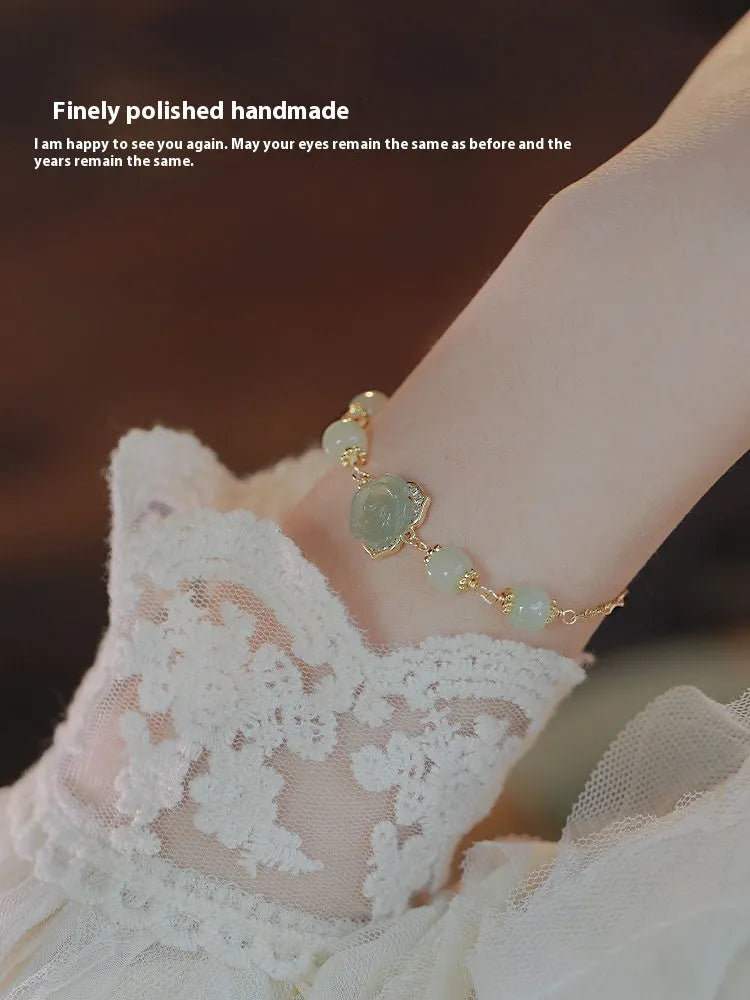 Handmade women's bracelet with rose-coloured Hetian Jade and 14K gold-plated finish in a floral design.