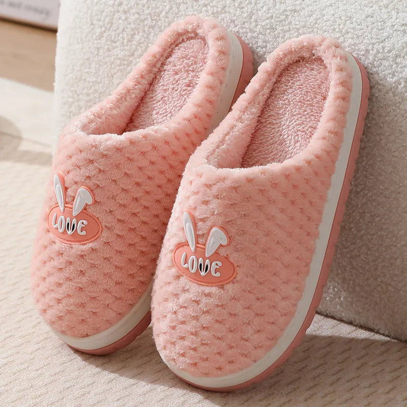 A pair of plush artificial fur house slippers with a baotou toe and a flat rubber sole, shown in a choice of colours.