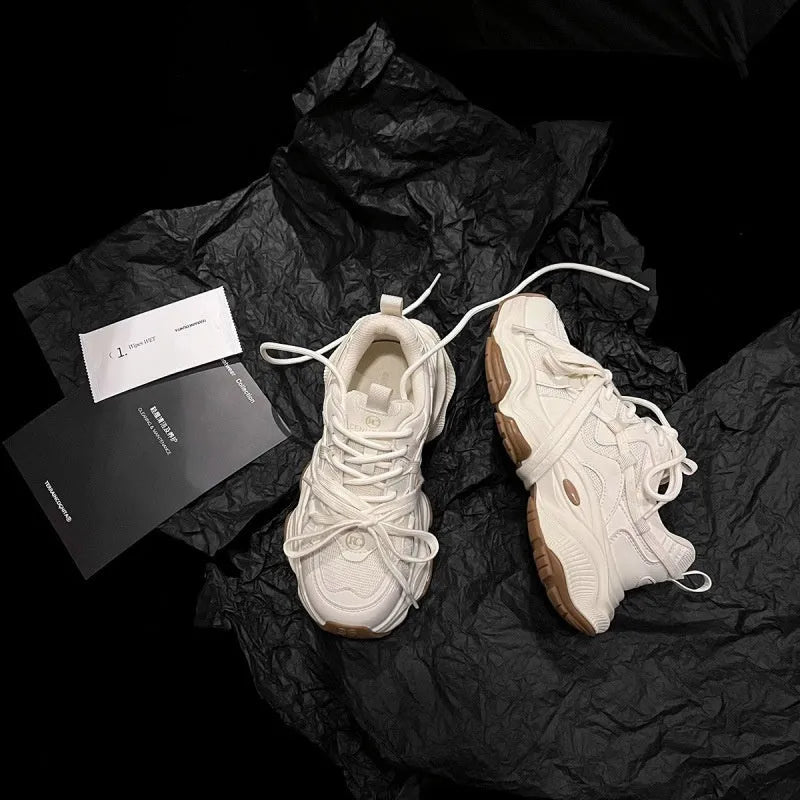 Women's beige and white platform sneakers with round toe and front lace-up design on a composite sole.