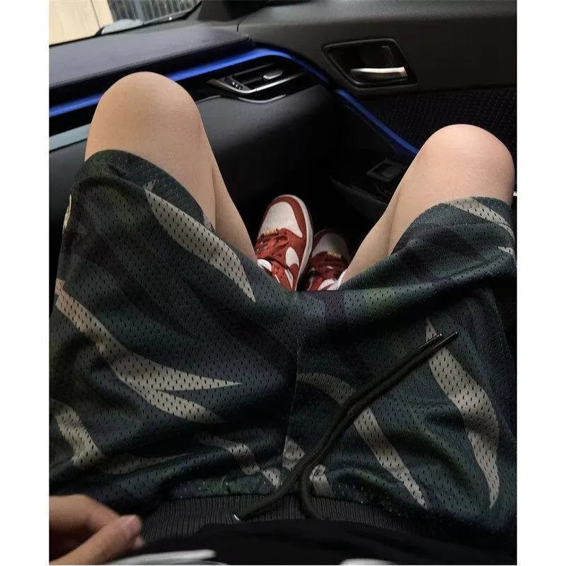 Men's straight-leg camouflage shorts in cotton blend polyester fabric on a mannequin.