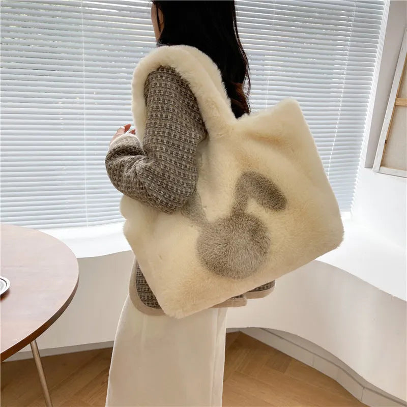 Soft beige plush tote bag with cartoon rabbit ears on the front, shown as a large capacity shoulder bag.