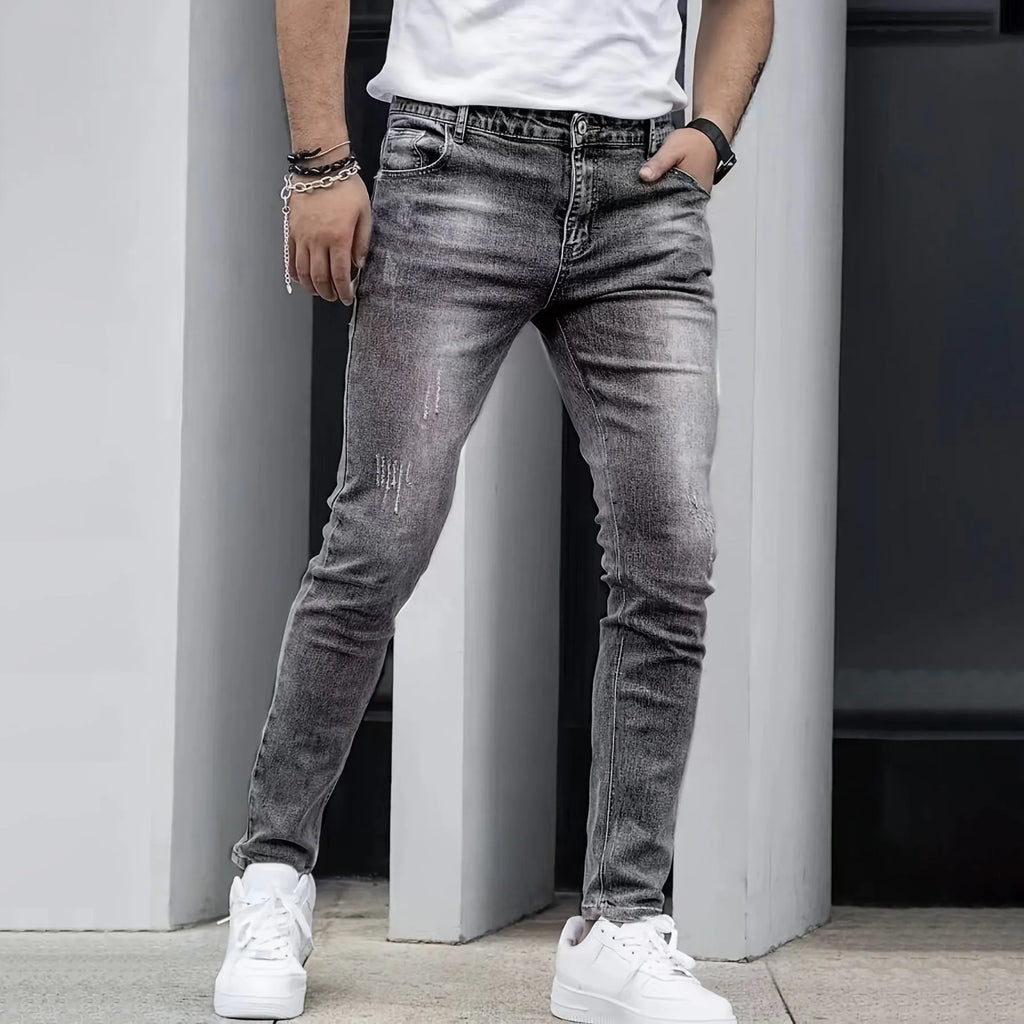 Men's straight leg jeans in stretch cotton denim showing high elasticity fabric and slim silhouette