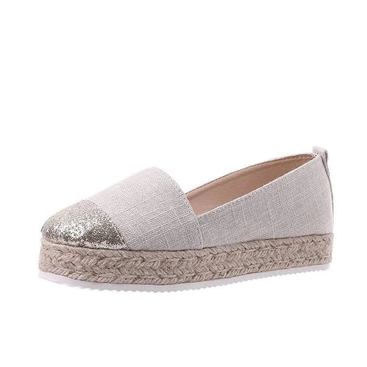 Women's plus size black canvas slip-on flat shoes with round toe, shown from the side.