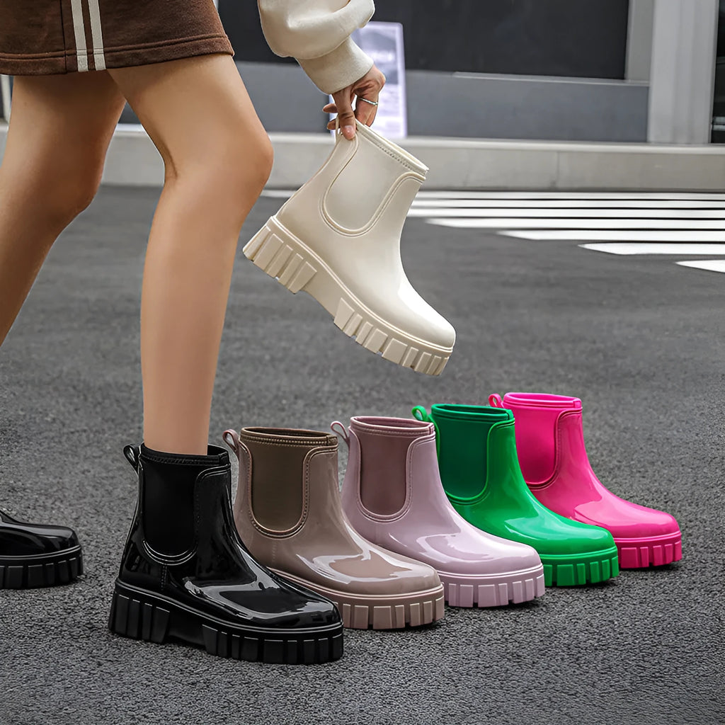 A pair of low tube PVC rain boots with a flat heel, shown in a solid colour on a white background.