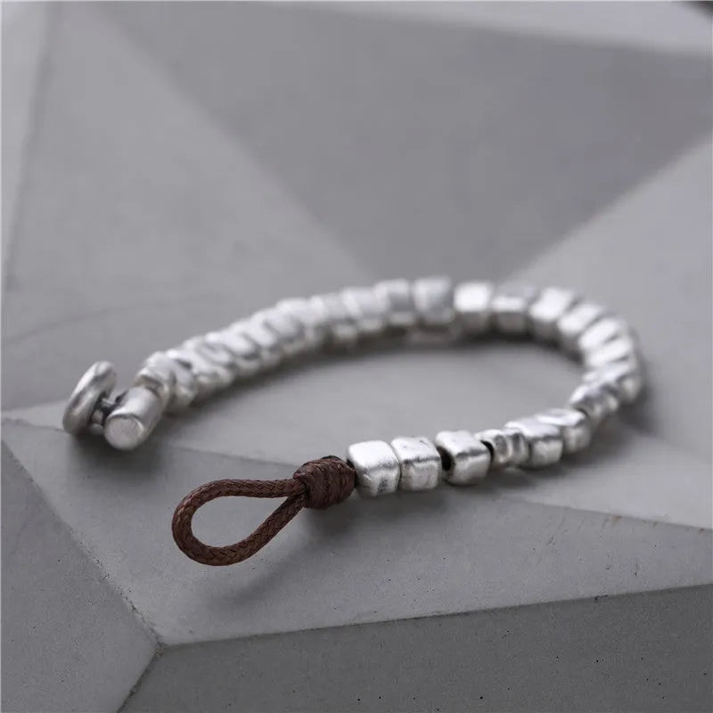 Handmade women's bracelet with irregular square design in wood and silver materials on elastic band