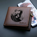 Men's brown leather wallet with a gold zipper closure laid flat.