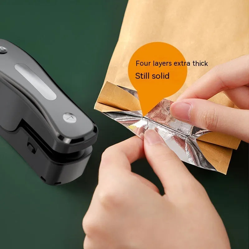 Milky white portable kitchen sealer with USB charging cable and compact dimensions