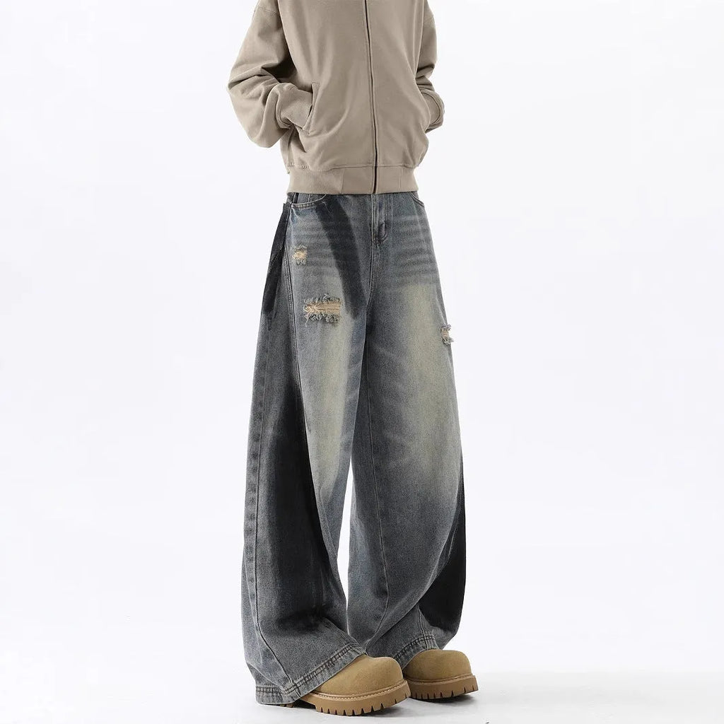 Men's blue ripped jeans with splash-ink wash pattern and loose fit silhouette