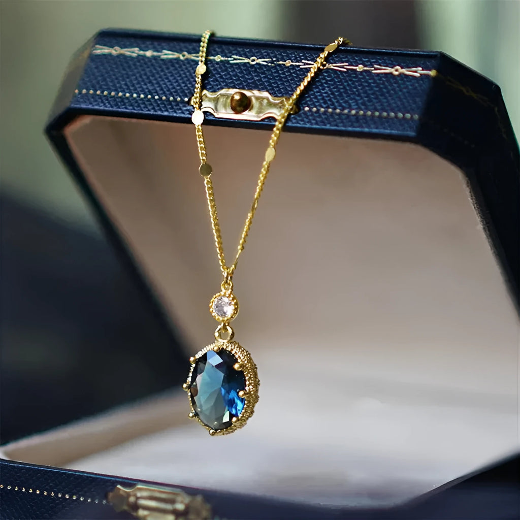 Gold-coloured geometric pendant necklace with a French retro design on a chain.