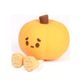 Soft orange pumpkin-shaped silicone night light with a warm glow, showing its compact size on a table.