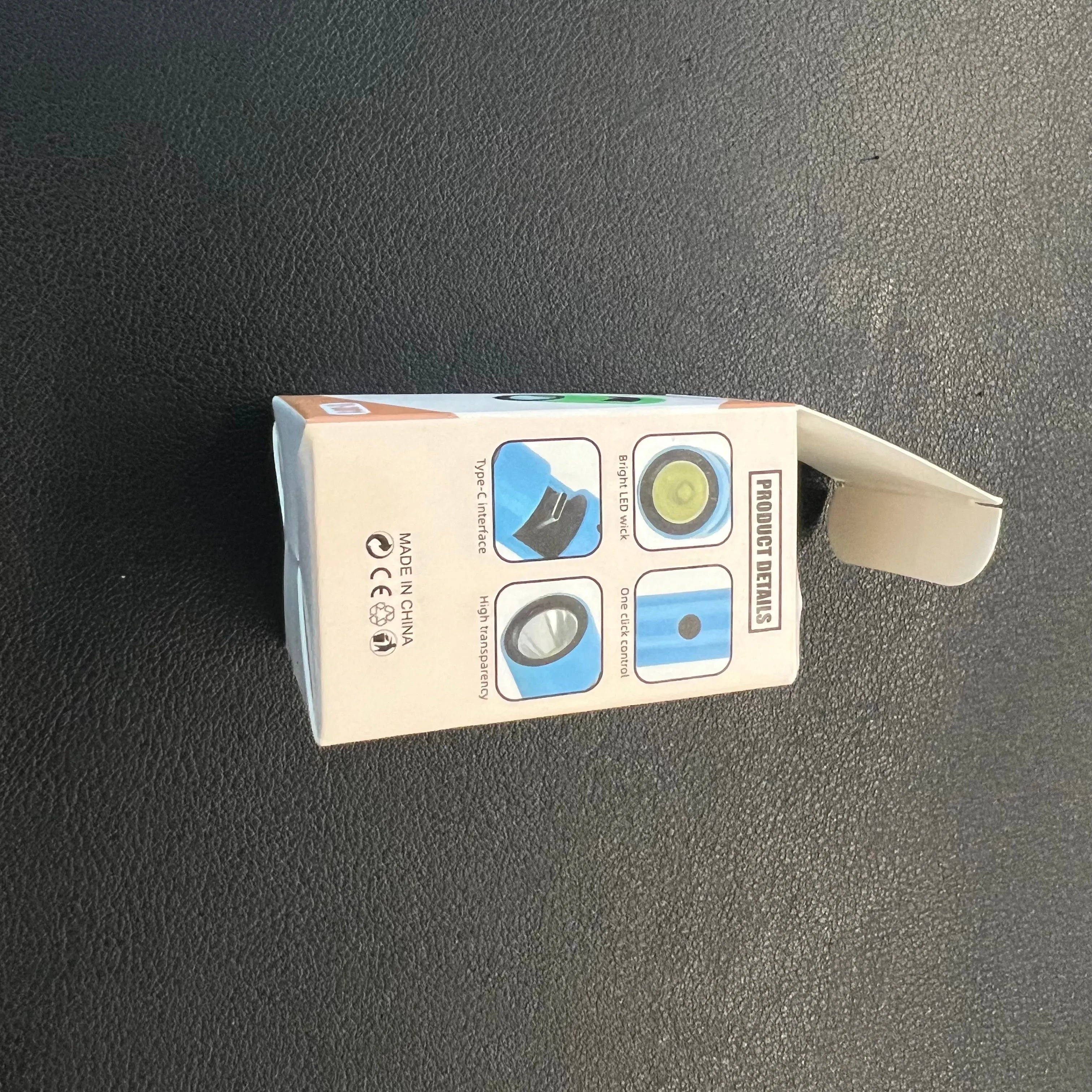 Green mobile phone mini torch with Type-C interface and LED light wick on a keychain