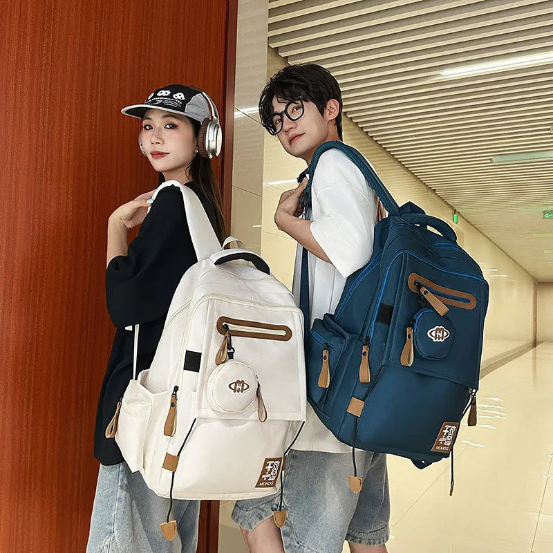 Large black waterproof nylon travel backpack with contrast stitching, shown with a 20-35L capacity.