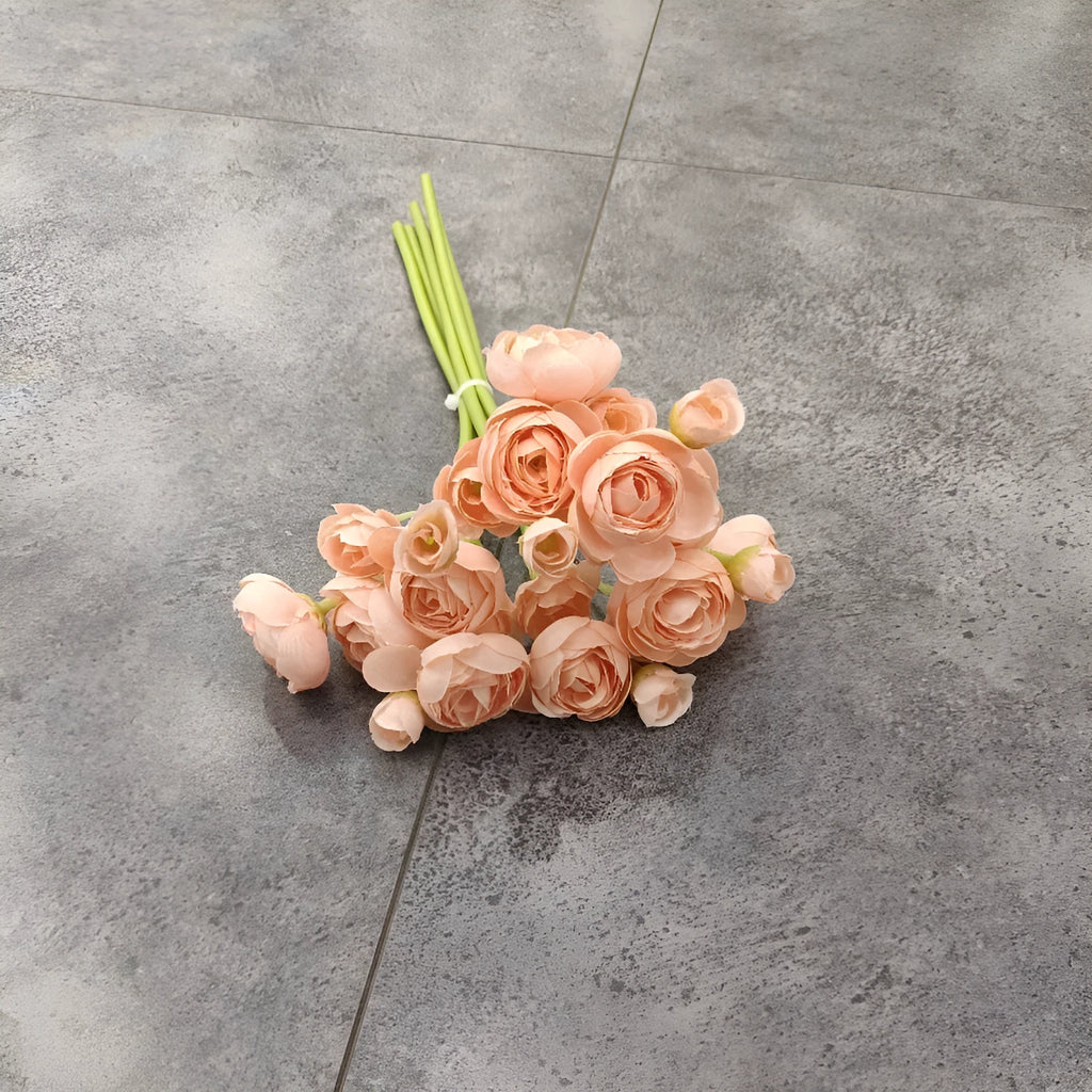 Simulation mini bridal bouquet with silk flowers in white on a table for home decoration