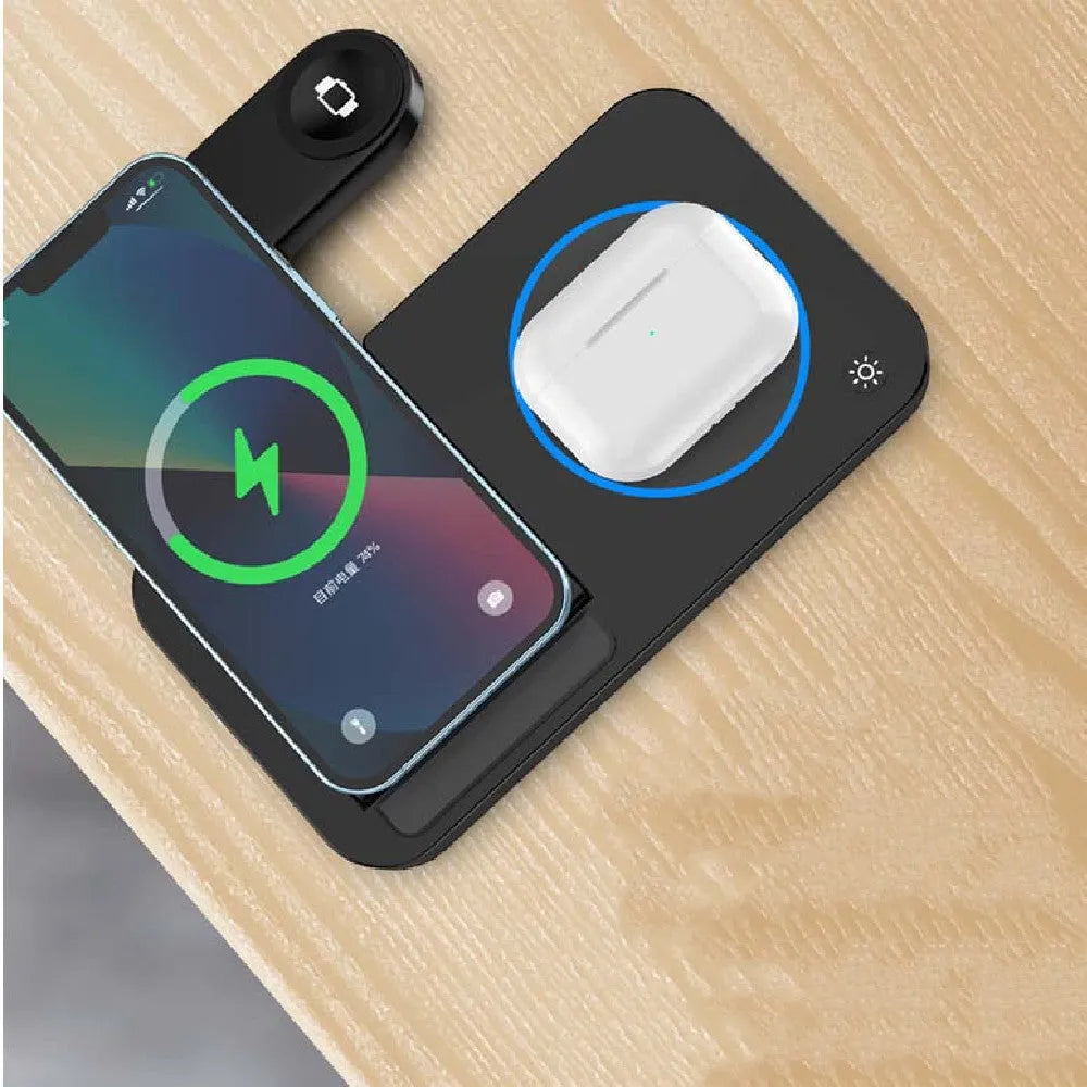 Folding three-in-one wireless charging stand in black with phone, headphones, and watch placed on charging areas