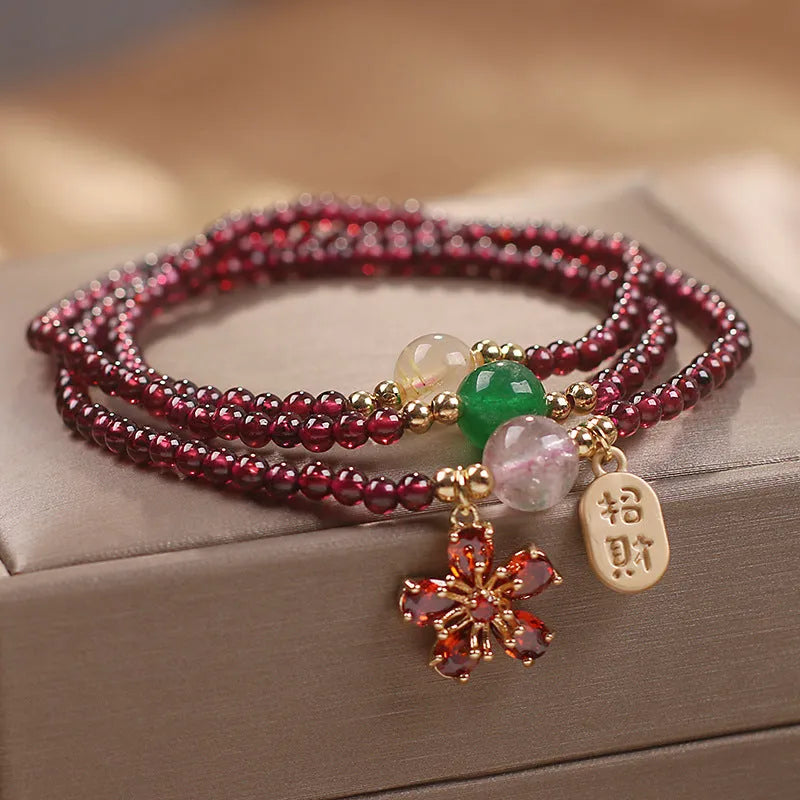 Women's crystal pomegranate bracelet with red cherry blossom beads and sequin detailing