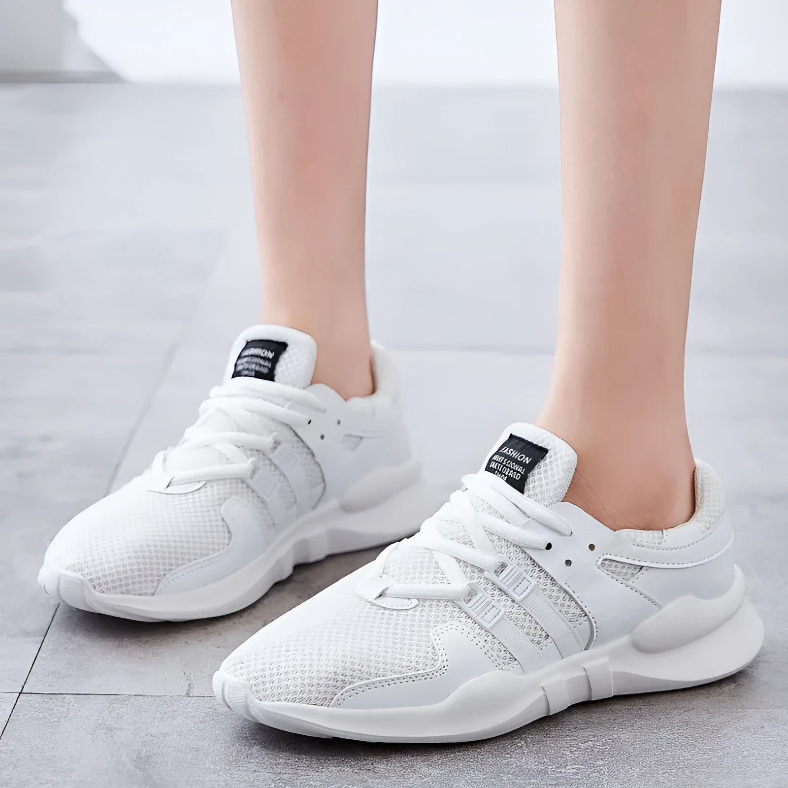 Men's breathable mesh sneakers with hollow-out design and flat EVA sole in black and white colour options