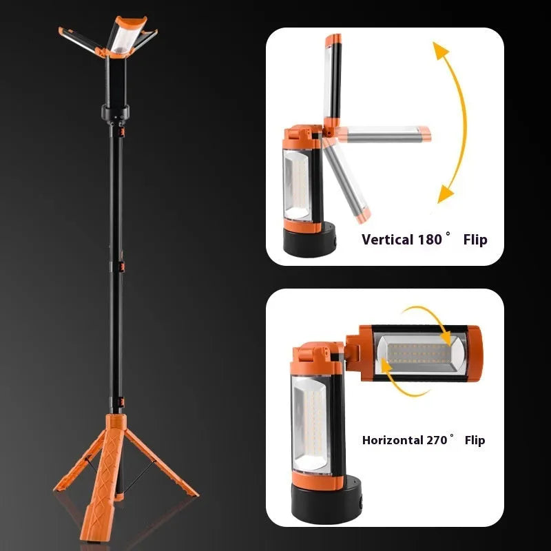 Retractable folding charging camping lantern in black and orange with bracket and pull string extended on a table