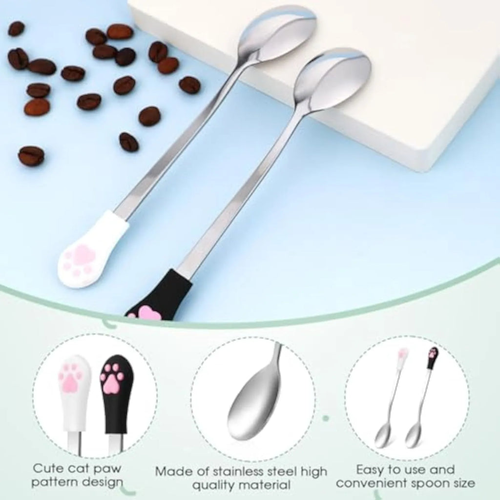 White and black pet food spoons with cat paw designs and silicone handles