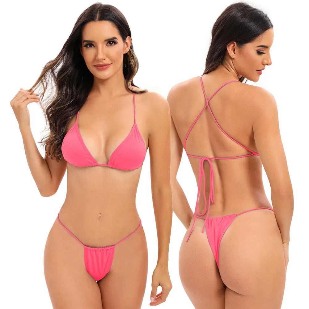 Women's striped one-piece swimsuit with cross-strap back, shown in a candy colour.