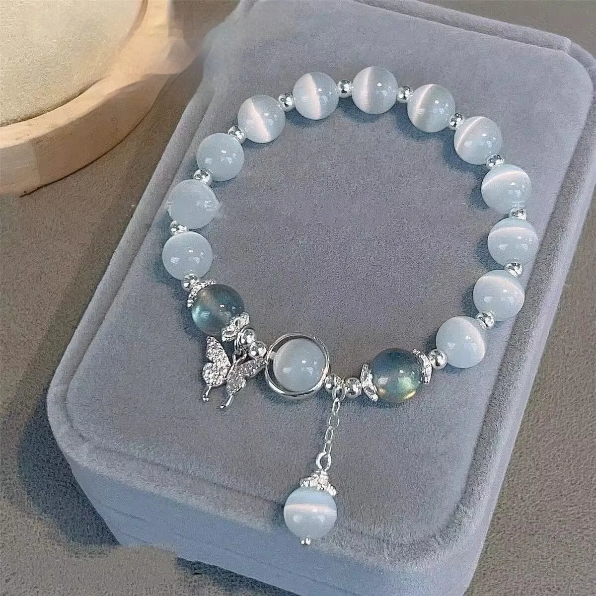 Glass butterfly bracelet for women with drop-shaped coloured glaze beads in grey moonlight colour option