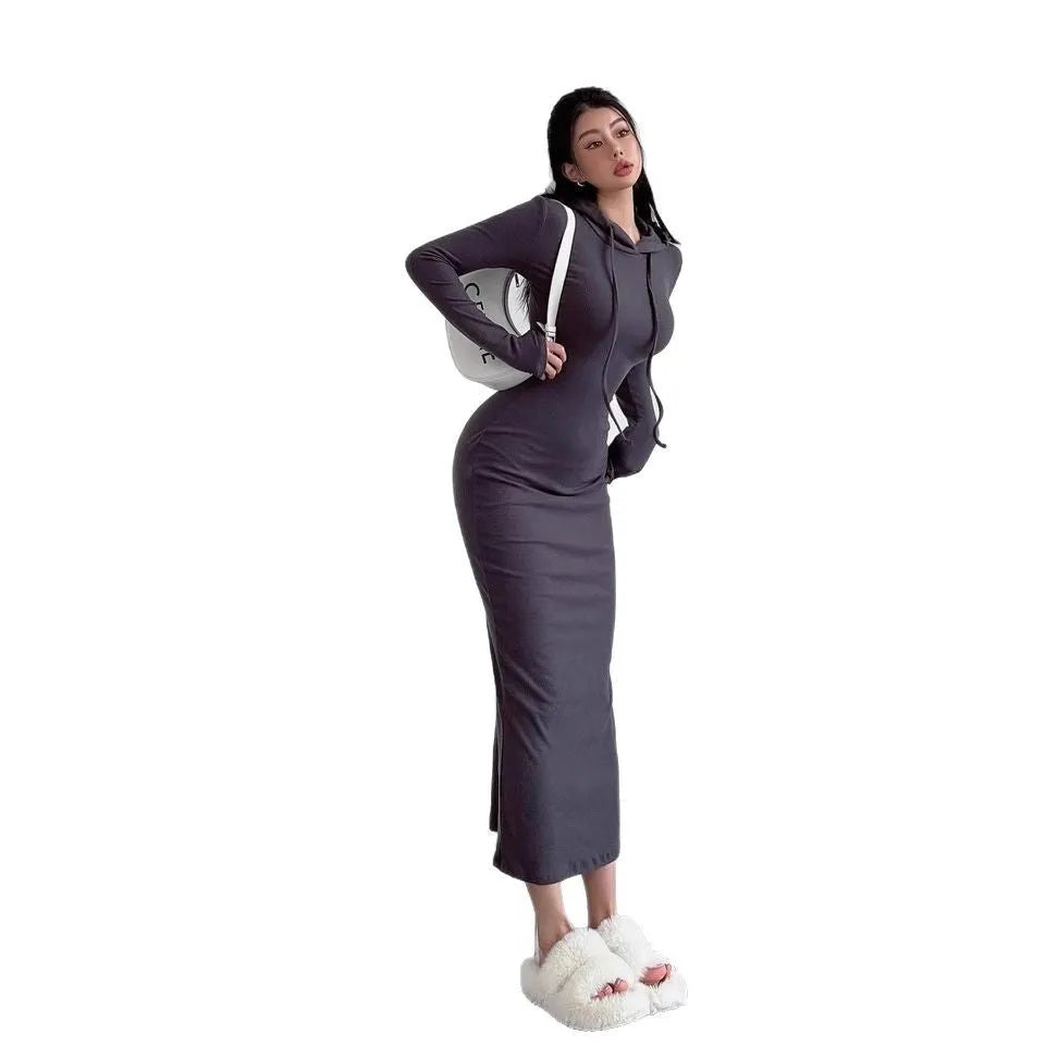 A woman's light grey hooded sheath dress with long sleeves, high waist, and over-the-knee length.