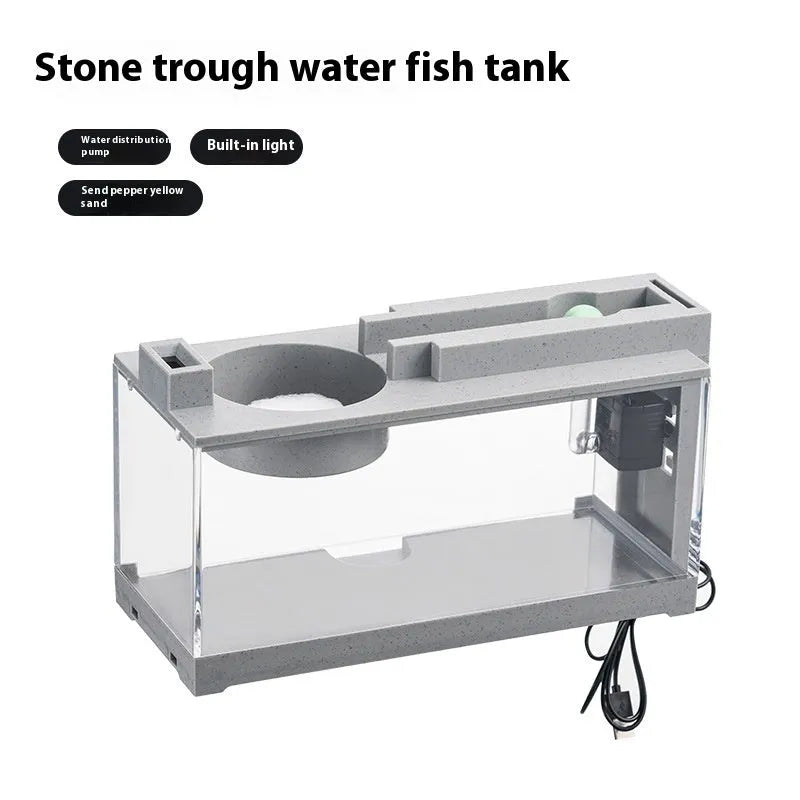 Small stone trough plastic fish tank with water pump and built-in light on a desk