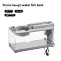 Small stone trough plastic fish tank with water pump and built-in light on a desk