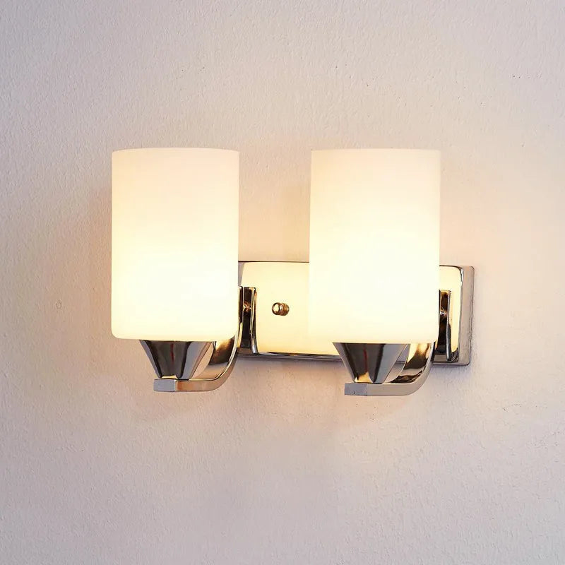 Chrome-finished modern wall lamp with glass shade, shown in single head configuration.