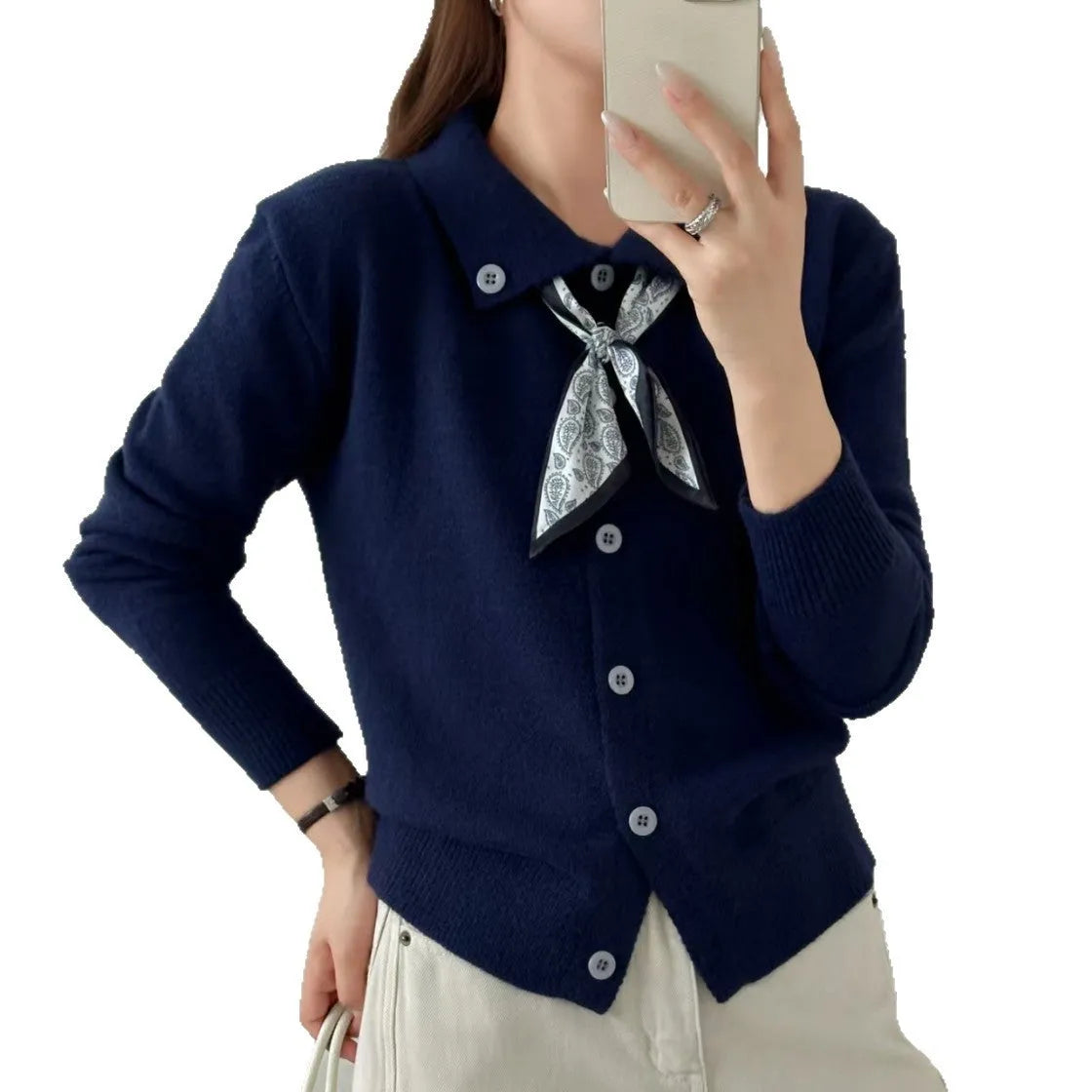 Milky white acrylic fibre cardigan sweater with a lapel scarf and long sleeves laid flat
