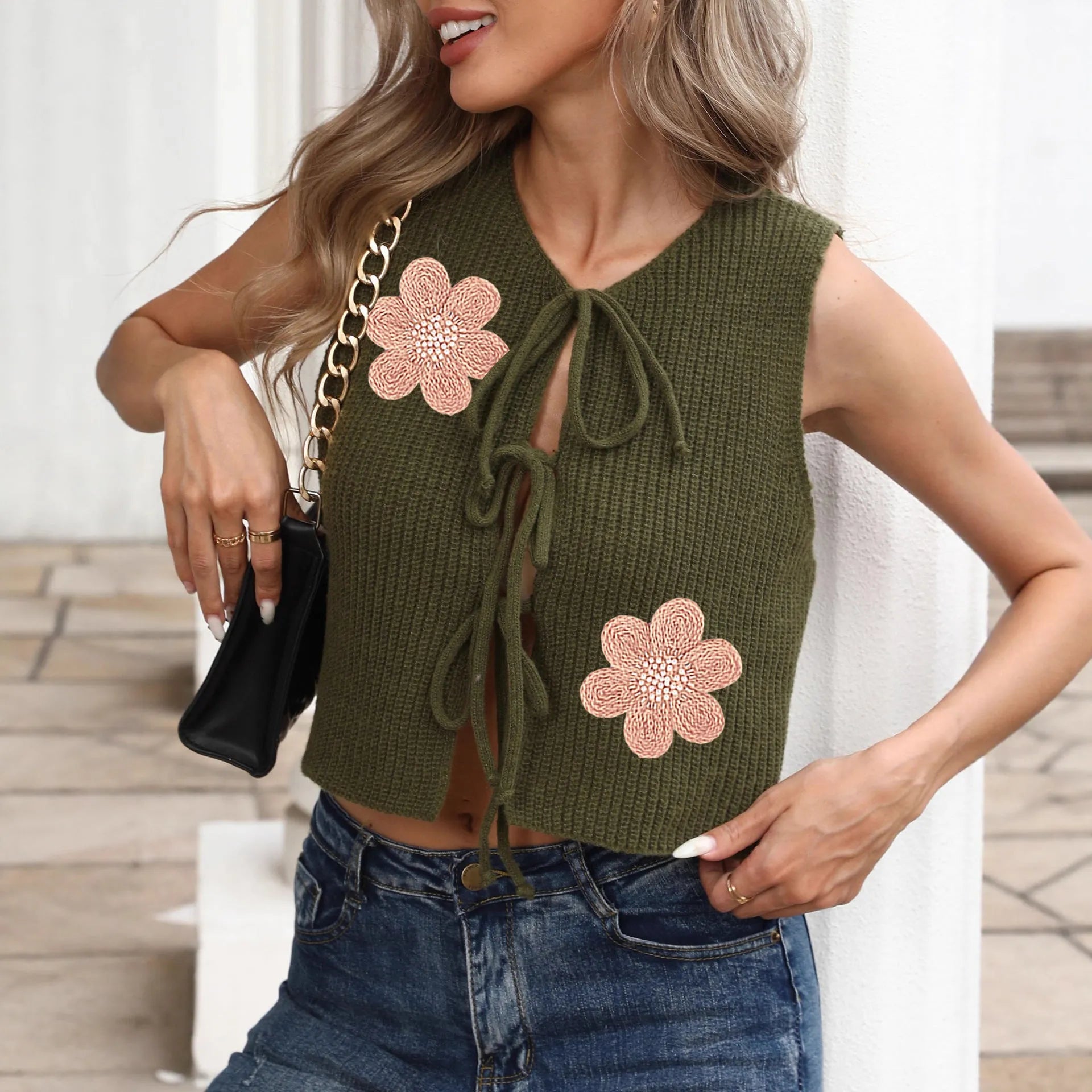 Short white sleeveless cardigan vest for women with lace-up bows and a flower pattern.