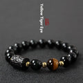 Obsidian bracelet with 10mm yellow tiger eye beads showing manual processing details and retro circle style