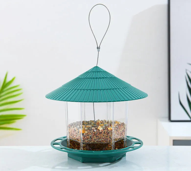 Green PP hanging transparent bird feeder with automatic feeding for outdoor garden use