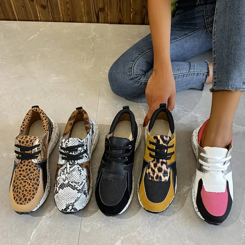 Women's casual suede sneakers with a wedge heel in black, leopard, pink, and snake pattern colours.