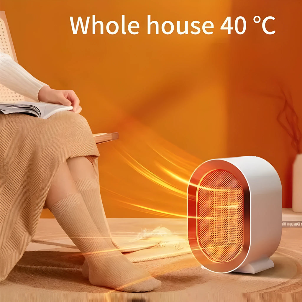 Desktop electric fan heater with black casing and UK plug, showing control knob and air vents