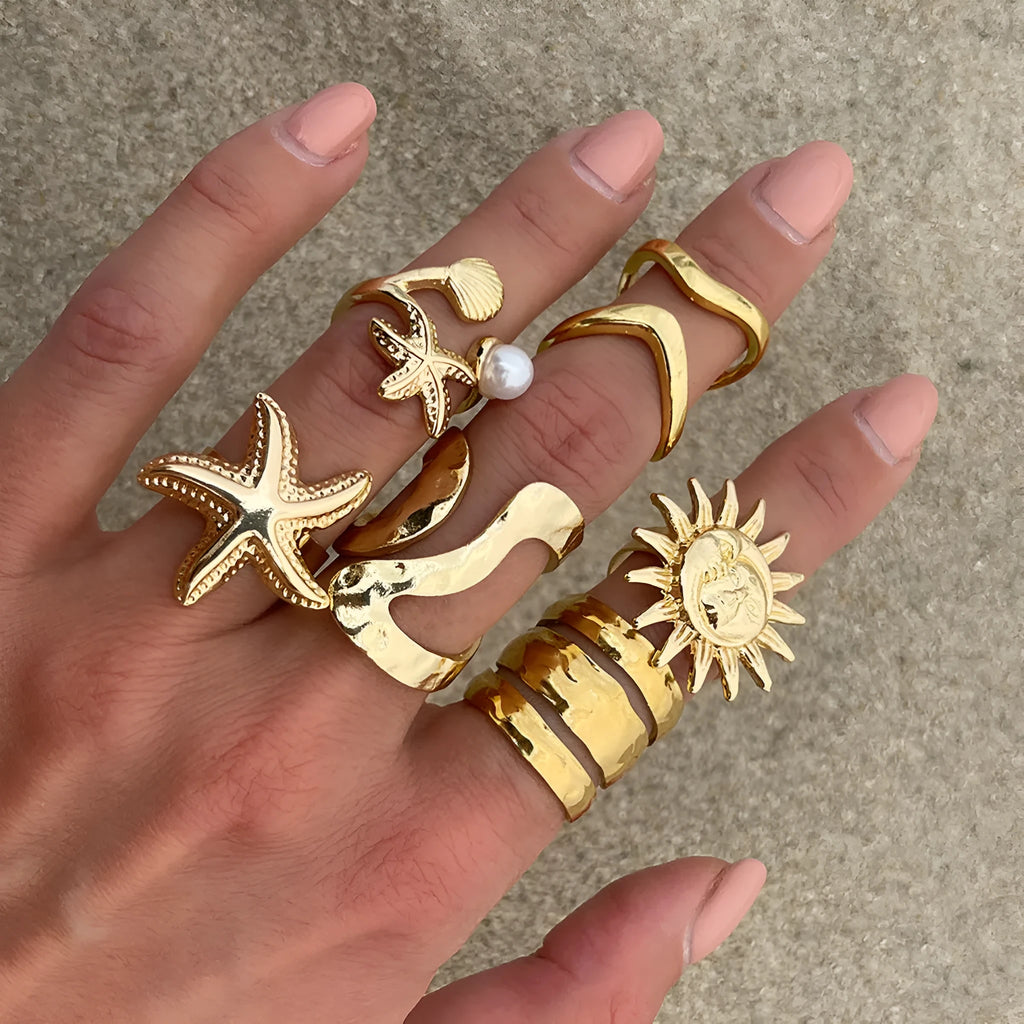 Women's irregular ocean shell ring set with starfish and fan shapes, light gold electroplated metal, 4-piece arrangement