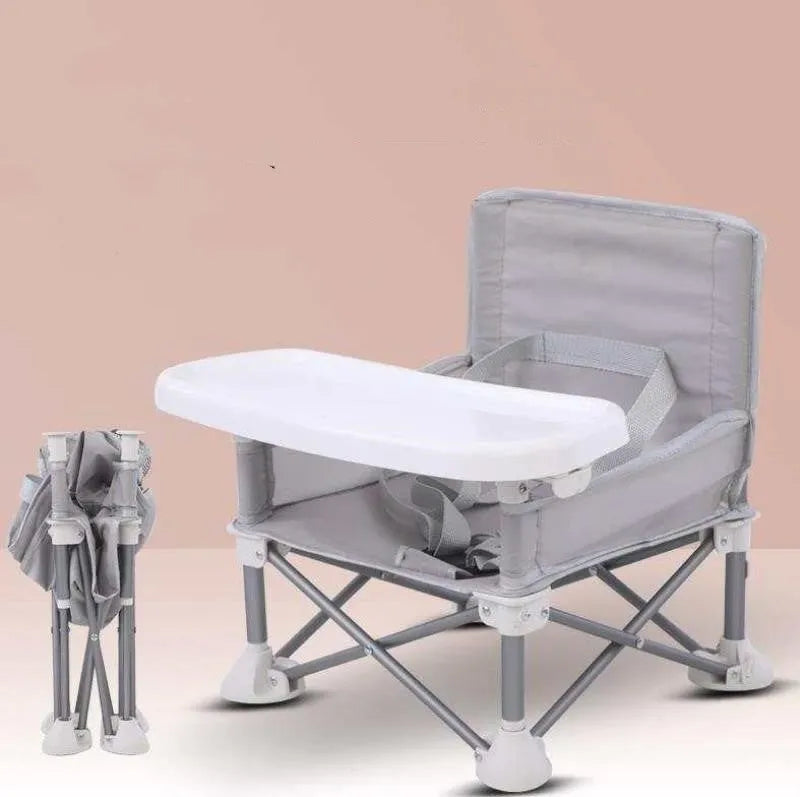 Foldable baby dining chair with safety belt, removable tray, and storage bag in pink