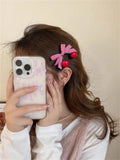 Red love heart-shaped plastic hair clip with retro dots and a willow leaf silhouette on a white background.