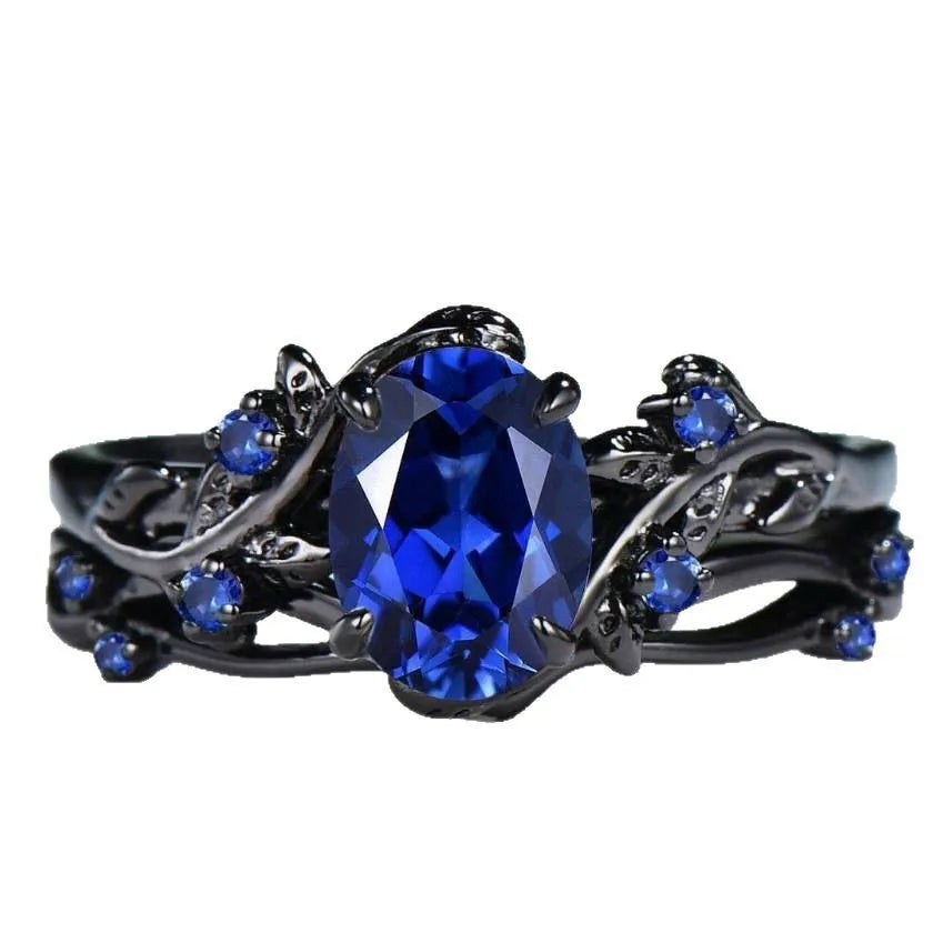 Geometric gun black women's couple ring with a navy blue rhinestone inlay on a copper band.