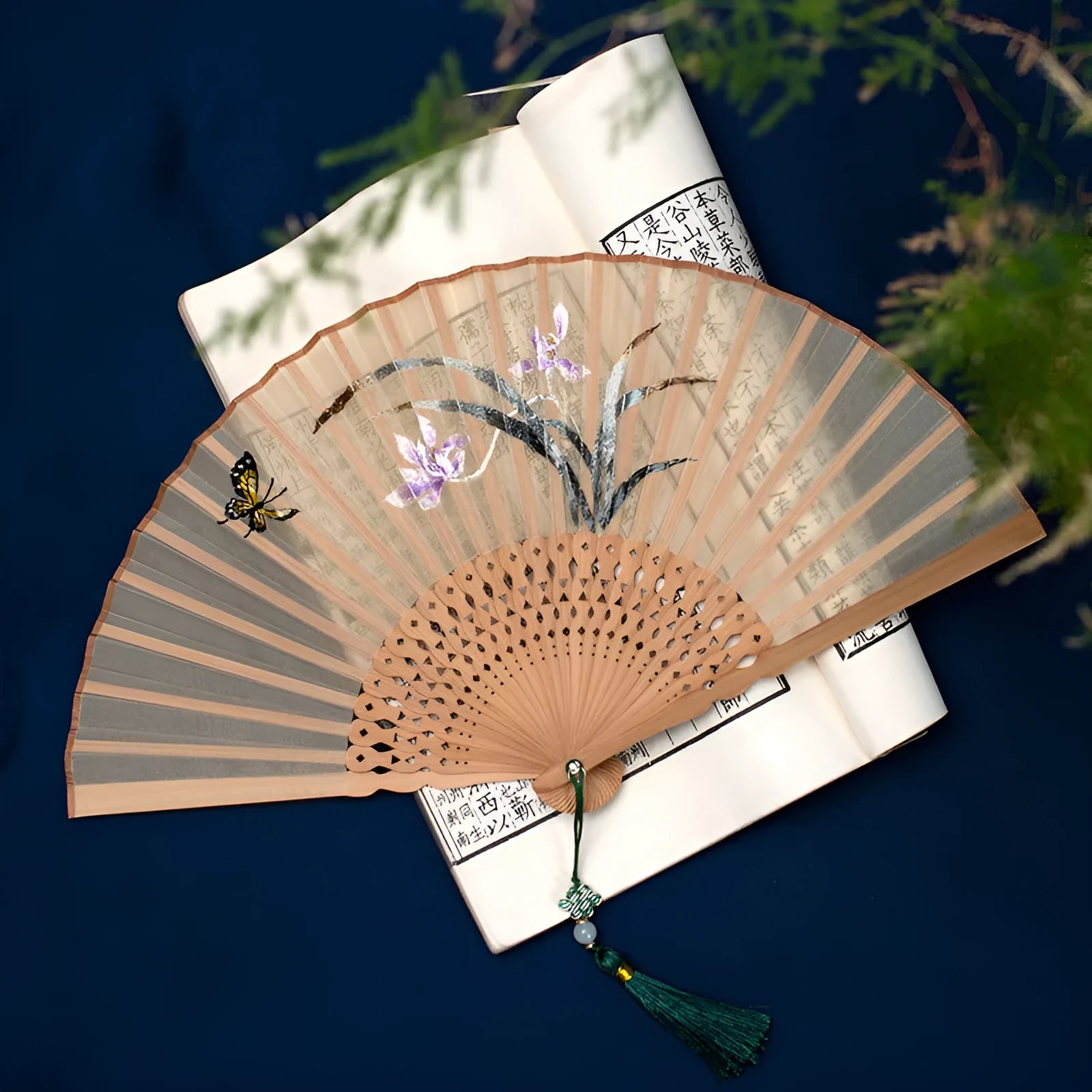 Bamboo frame silk embroidered folding fan showing intricate traditional patterns with folded and open positions