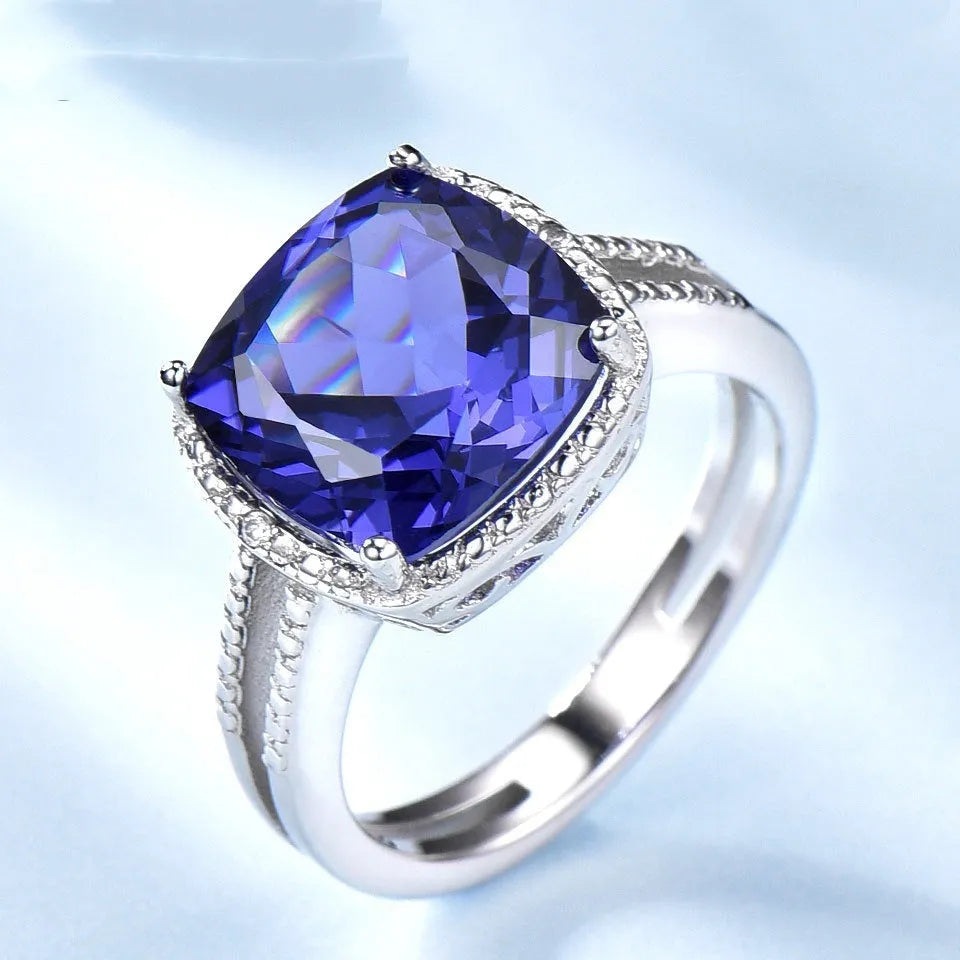 A blue tanzanite stone set in a sterling silver women's ring, showing front detail.