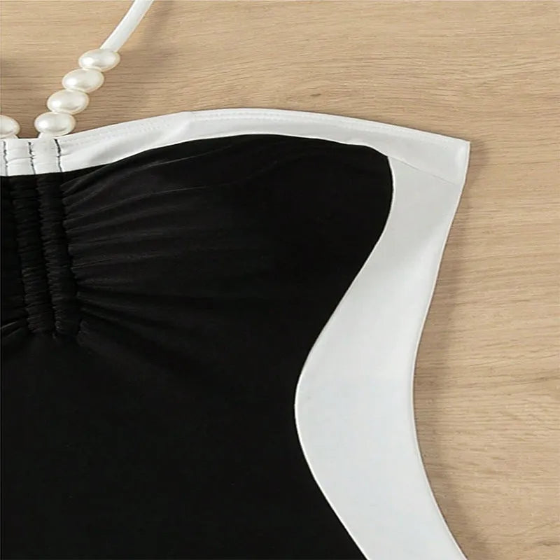 Black and white women's one-piece swimsuit with pearl spaghetti straps and slim-fitting design