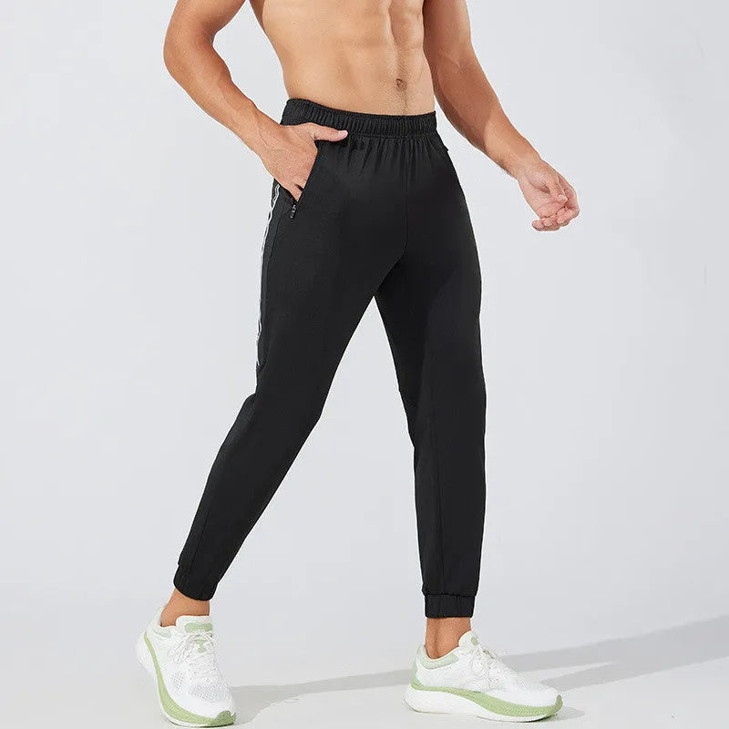 Men's black polyester running trousers with mid-waist design for exercise and leisure activities