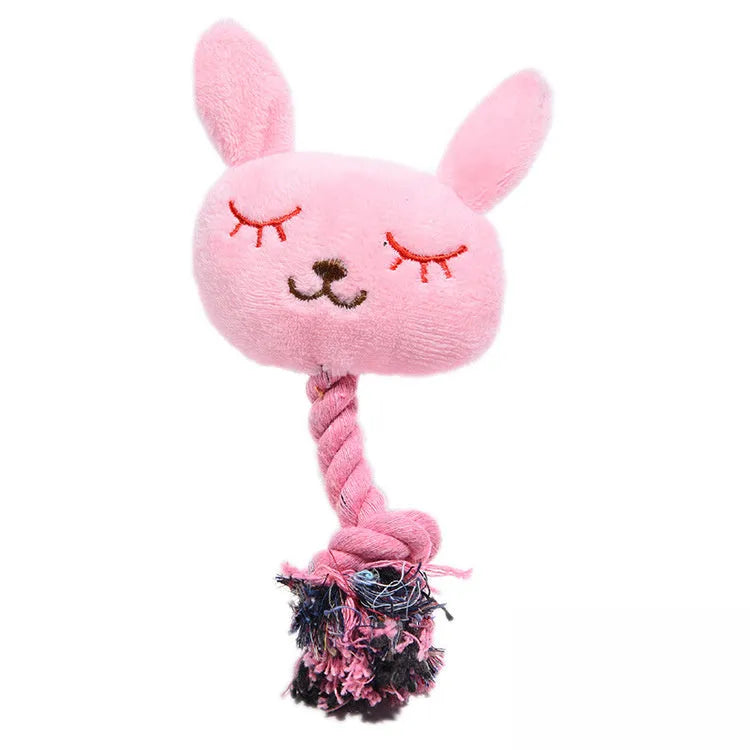 Pink rabbit-shaped plush squeaky dog toy with bite-resistant fabric placed on a light background