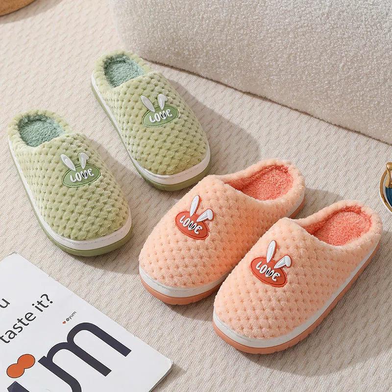 A pair of plush artificial fur house slippers with a baotou toe and a flat rubber sole, shown in a choice of colours.