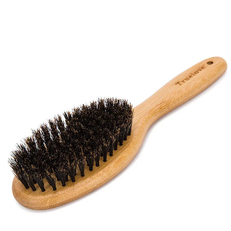 Medium pet deshedding comb with bamboo handle and stainless steel needles in original bamboo colour on a flat surface