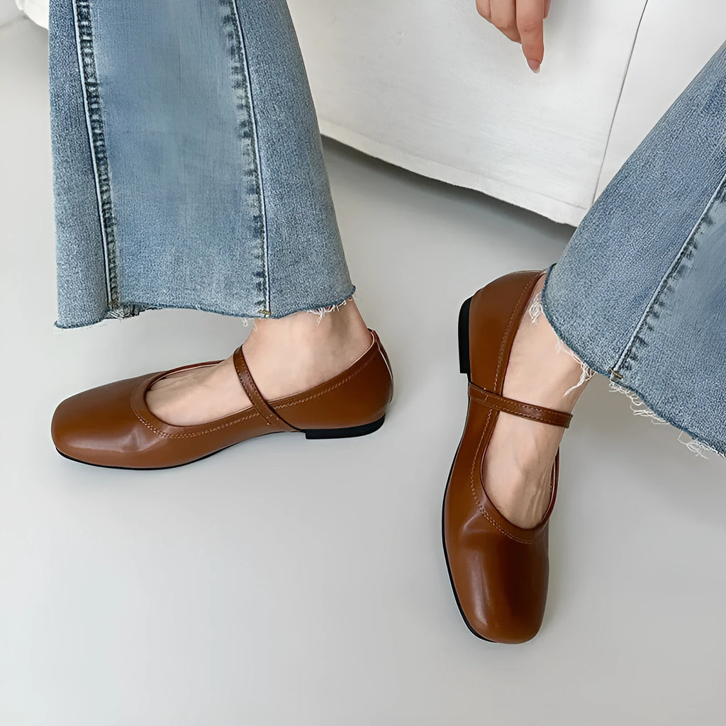 Women's retro black sheepskin Mary Jane flat shoes with a round toe and ankle strap on a rubber sole.