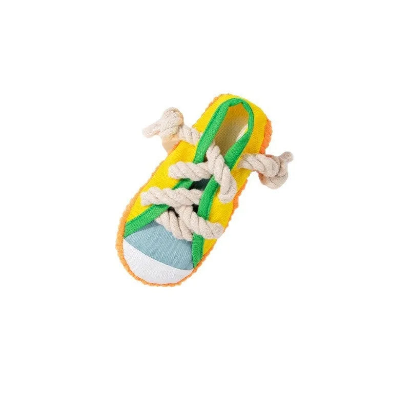 Plastic dog toy shaped like slippers in yellow, black, or blue, designed for chewing and making sound.
