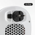 White portable ceramic electric heater with remote control on table