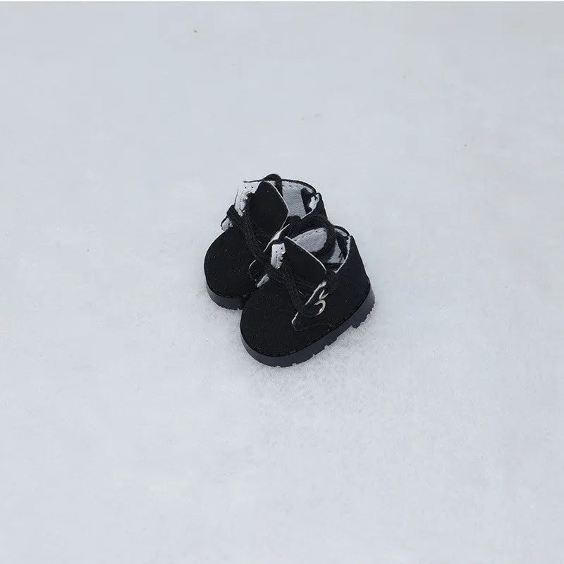 A pair of 17cm scale PU doll shoes in a selected colour and style, such as black leather shoes or brown boots.